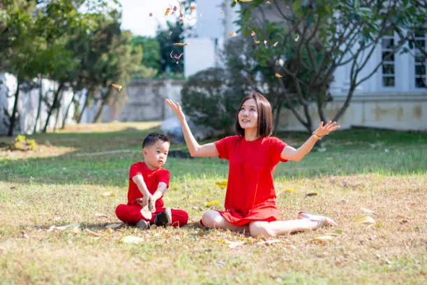 Chinese New Year Boy and mommy play leaf up