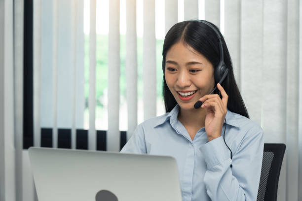 istock Close up call center worker was smiling at his office. 1300435867