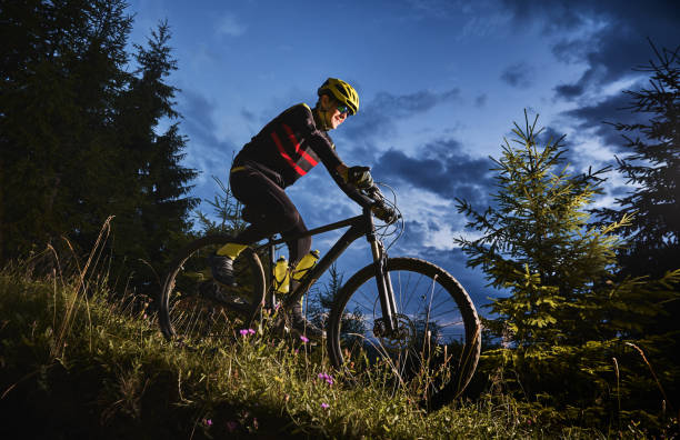 istock Cheerful male cyclist riding bicycle at night. 1300436006