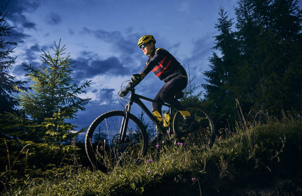 istock Cheerful male cyclist riding bicycle at night. 1300436012