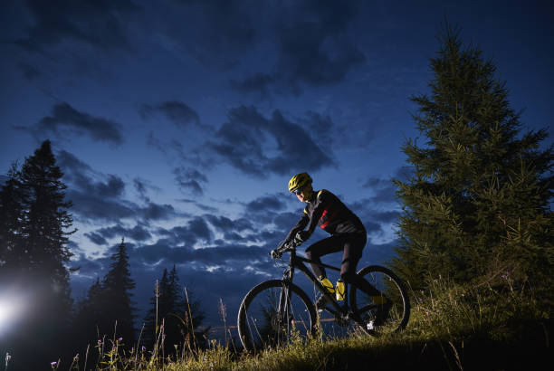 istock Cheerful male cyclist riding bicycle at night. 1300436016