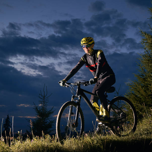 istock Cheerful male cyclist riding bicycle at night. 1300436017
