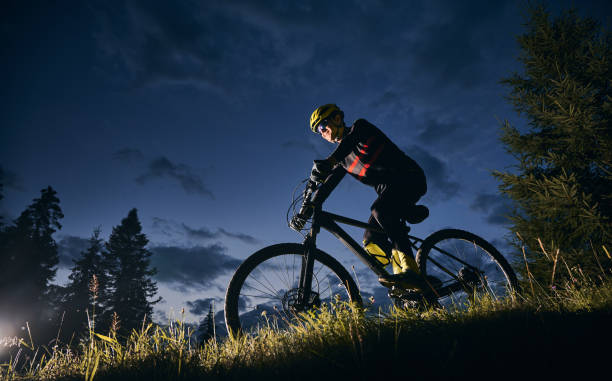istock Cheerful male cyclist riding bicycle at night. 1300436018