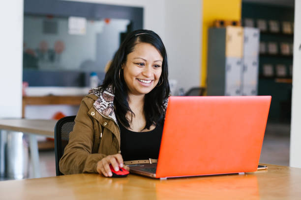 latin business woman working with computer at the office in mexico city - mexican ethnicity imagens e fotografias de stock