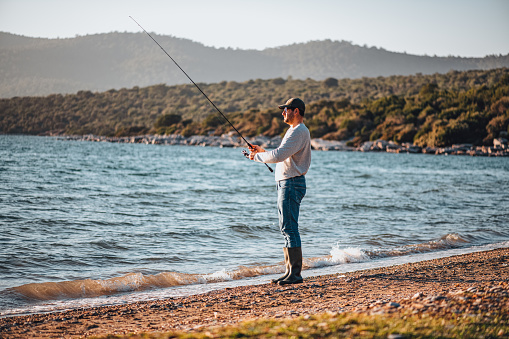 Young Man Fishing at the Beach