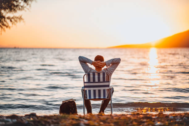 istock Man Enjoying the Beach at Sunset 1300441133