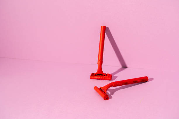 istock Red disposable razor on pink background, copy space 1300441842