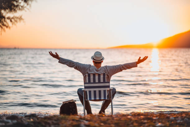 istock Man Enjoying the Beach at Sunset 1300441849