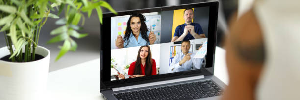 istock Woman talking with international colleagues using online video chat service at workplace 1300441975