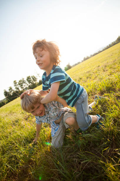 istock Boys fighting in nature 1300442043