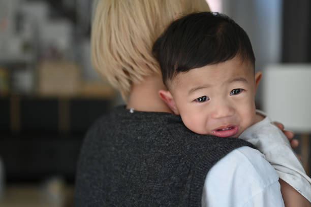 istock Young mother holding  her crying son at home. 1300442148