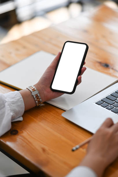 istock Close up view of young woman using smart phone during working at office. 1300442889