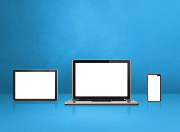 istock Laptop, mobile phone and digital tablet pc on blue office desk 1300444142