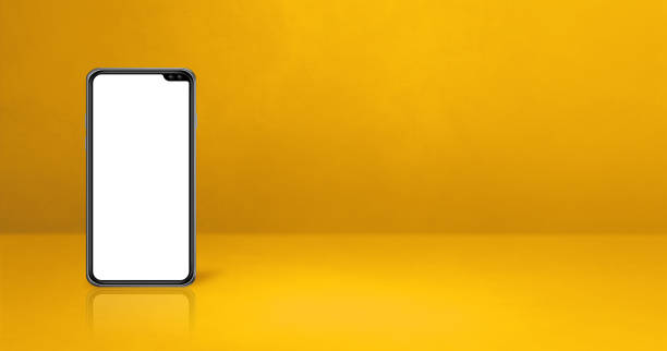 istock Mobile phone on yellow office desk. Background banner 1300444158