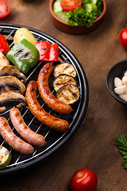 istock Grilled sausages, meat, and vegetables. 1300448438