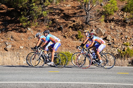 Four cyclists along a mountain road, Puerto de Alija, Malaga Province, Andalucia, Spain, Europe.