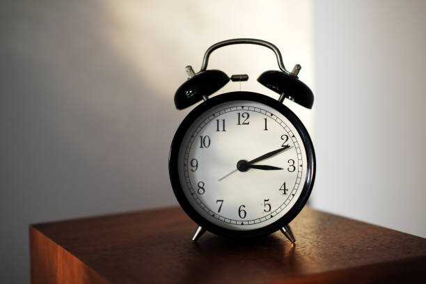 istock alarm clock on a shelf at home in afternoon sunlight 1300451068