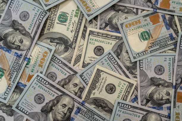 istock Close up view of money stack of 100 US dollars banknotes 1300453720