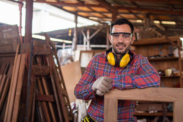 carpenter is working in a woodworking office.Worker Portrait caucasion white Carpenter standing and looking at camera carpenter is working in a woodworking office.Worker Portrait caucasion white Carpenter standing and looking at camera carpenter stock pictures, royalty-free photos & images