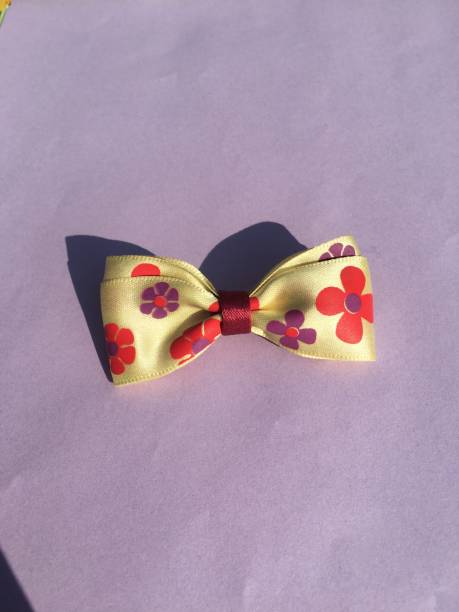 istock Multi flower bow tie with pastel purple background 1300455057