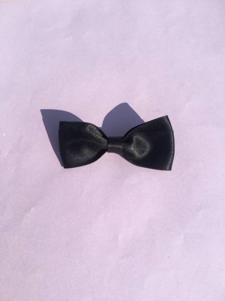 istock Groom black bow tie with pastel purple background 1300455151