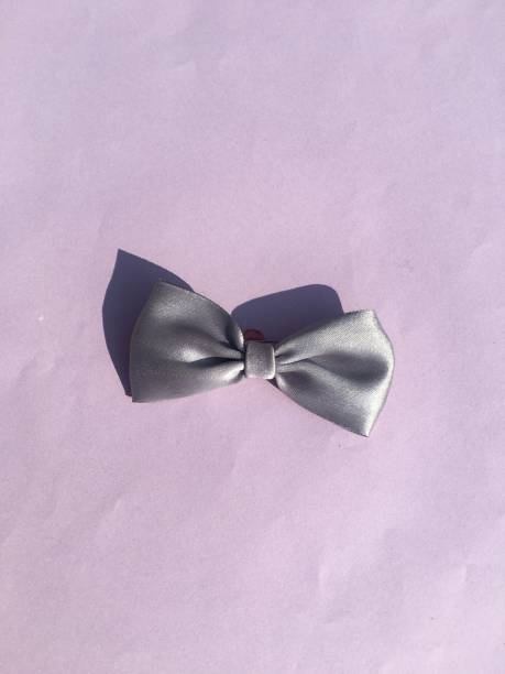 istock Gray bow tie with pastel purple background 1300455313