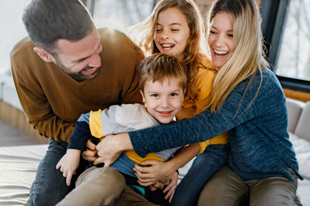 istock Cheerful family having fun while playing on sofa in the living room. 1300456092