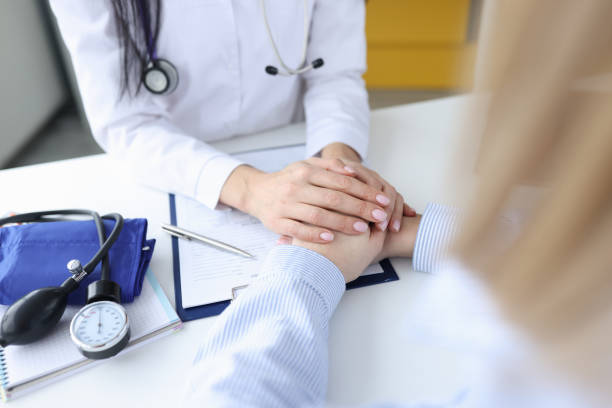 istock Doctor's hands lie sympathetically on patient's arms 1300457507