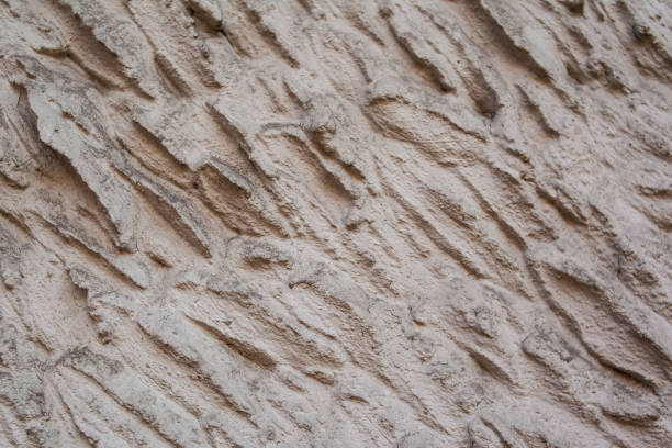 istock close up of old grunge painted wall wsith waves on it. 1300457656
