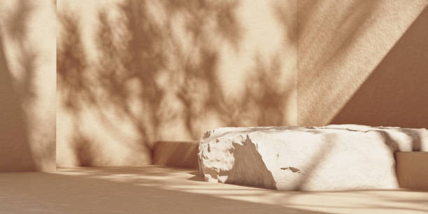 istock Stone plate podium on beige wall with leaf shadows 1300458013