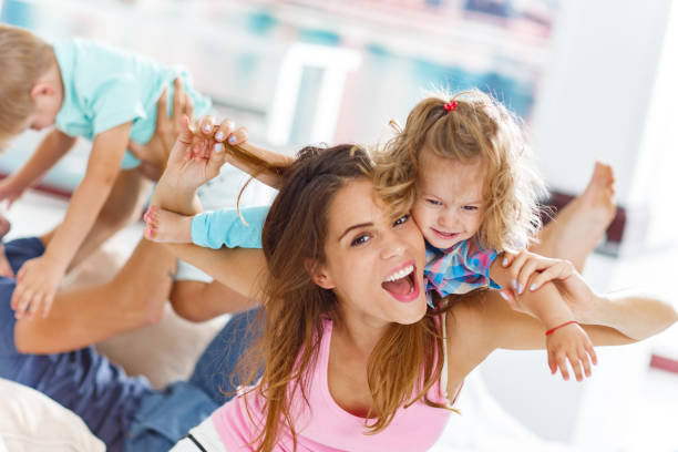 istock Playful mother having fun with their daughter at home. 1300458942