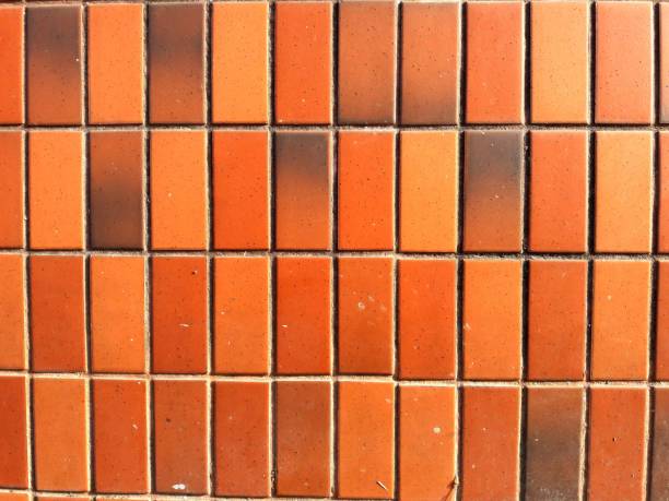 istock Orange and red mosaic tiles, background texture 1300460030