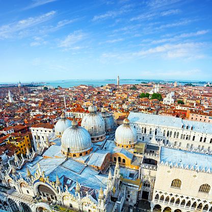 Wide Angle aerial view of Venice, Doges Palace and Saint Mark's Basilica on front. Composite photo