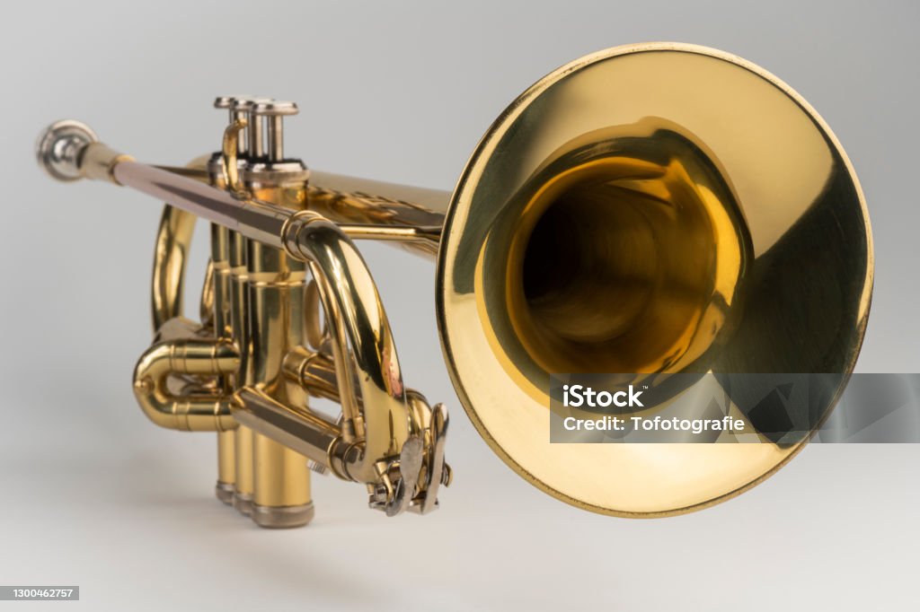 Gold colored trumpet as an isolated musical instrument against a white background in a studio Trumpet Stock Photo