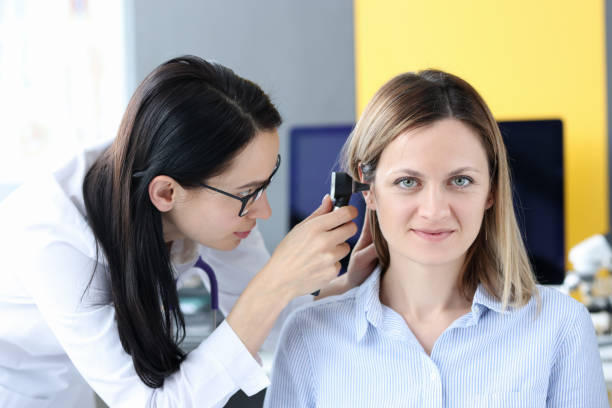 Doctor examines patient's ear with an otoscope Doctor examines patient's ear with an otoscope. Otolaryngologist services concept ear drumm stock pictures, royalty-free photos & images