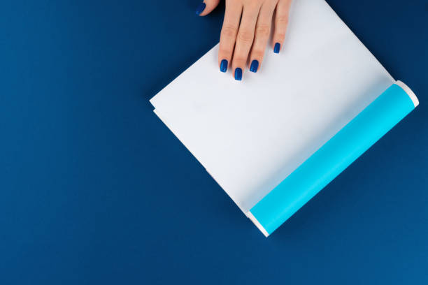 istock Female hands holding blank magazine with copy space 1300463077