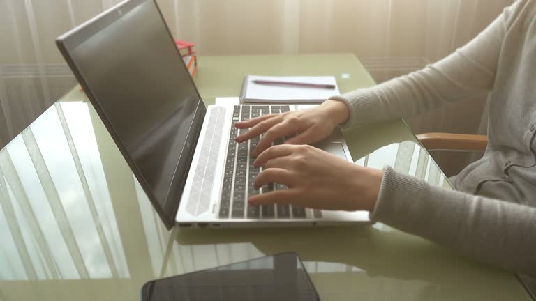 The girl working at home office hands on keyboard.