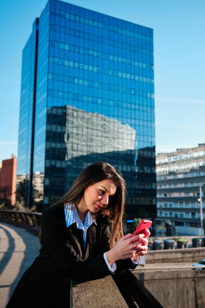istock Business woman using her mobile phone outdoors. 1300464035