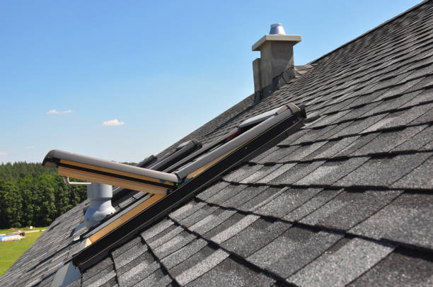 istock A gray roof covered with dimensional architectural asphalt shingles with an attic skylight, ventilation pipe, air duct and chimney. A close-up on an open attic skylight. 1300464619