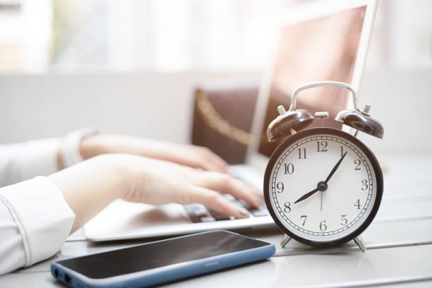 istock Business working times concept people work typing on laptop computer overlay with in time clock in the morning 1300464700
