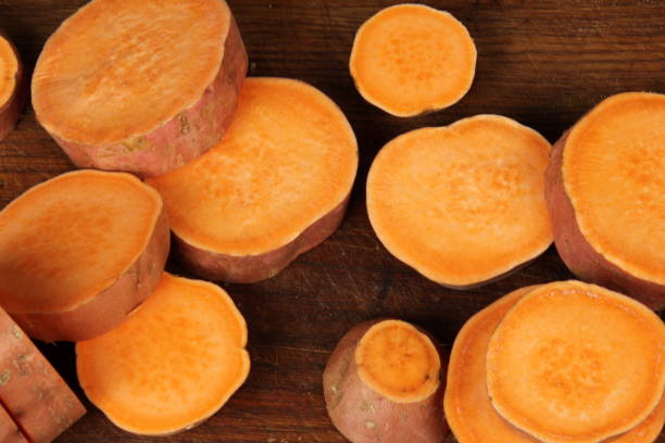 istock Sliced sweet potato on wooden board background 1300466970