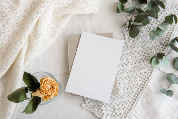 istock Vintage white background and blank postcard - white background, yellow roses, eucalyptus sprig and copy space. A romantic greeting card. 1300467175