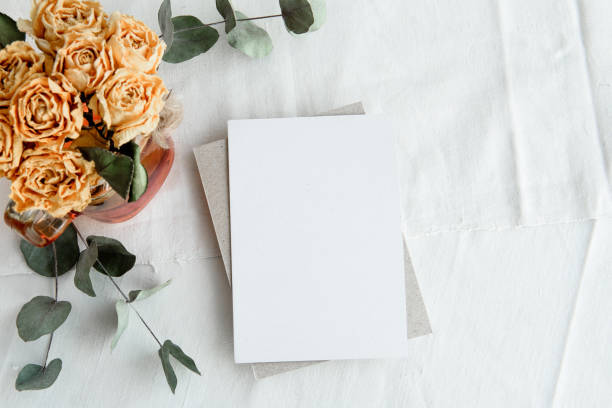 istock Trendy white background and blank postcard - white background, yellow roses and copy space. A romantic greeting card. 1300467209