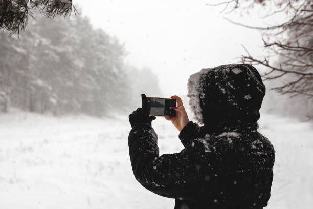 istock Girl walks with dog during heavy snow 1300467341