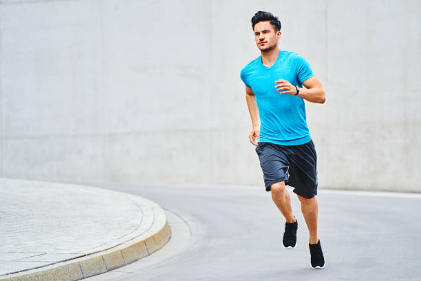istock Young fit man running in the city 1300467368