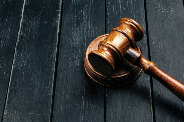 istock Judge's gavel on wooden table in dark 1300469291