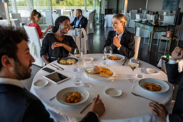 istock Happy business colleagues dining together 1300469896