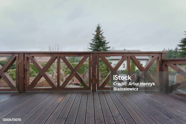 View Of The Balcony With A Plank Floor And A Railing Made Of Wooden Beams Stock Photo - Download Image Now