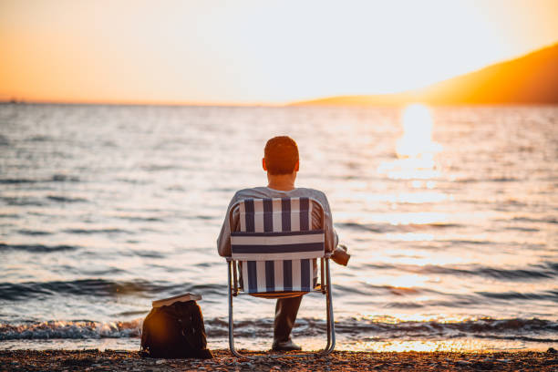 istock Man Enjoying the Beach at Sunset 1300470232