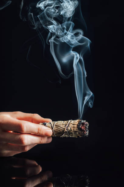 istock Smudging with Smoke from Dried Sage Smudge Stick 1300471340